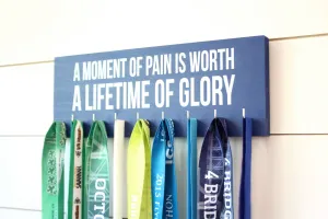 Medal Holder - A moment of pain is worth a lifetime of glory  - Medium - Running / Triathlon / Ironman / Obstacle / Tough Mudder / Spartan